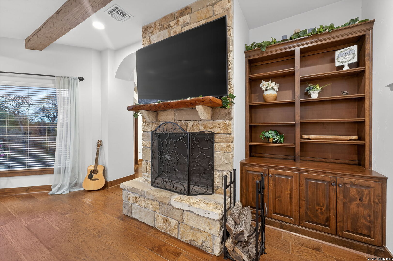 134 Bandit Beach Road New Braunfels, TX 78130 - Photo 10 of 77 a living room with furniture a flat screen tv and a fireplace