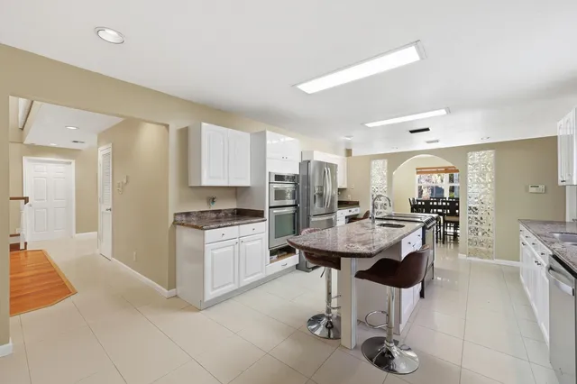 a bedroom with a large bed and a chandelier