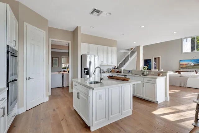 a kitchen with a stove a sink and a refrigerator