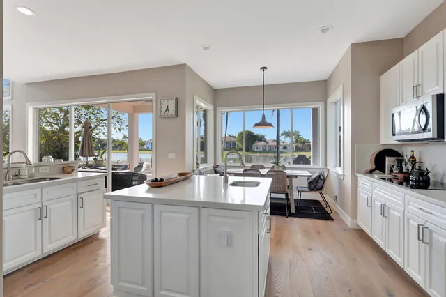 a kitchen with stainless steel appliances a stove refrigerator sink and cabinets