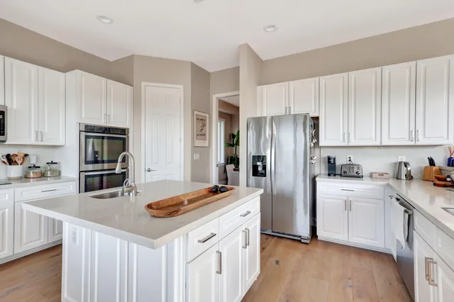 a dining room with furniture a chandelier and wooden floor