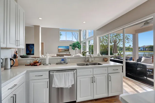 a view of a living room kitchen and a wooden floor