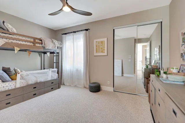 a spacious bedroom with two beds and a large window