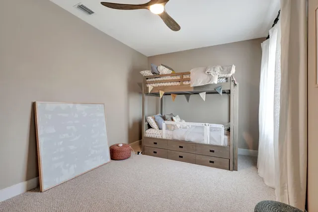 a bedroom with two beds and a chandelier