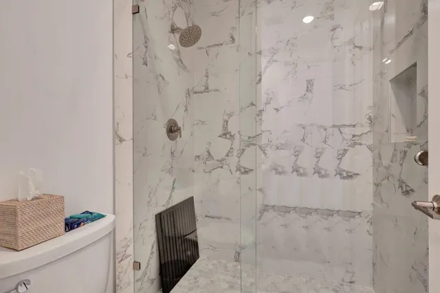 a spacious bedroom with a large bed and a flat screen tv