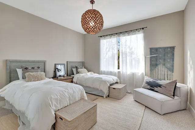 a bedroom with a large bed and a flat screen tv