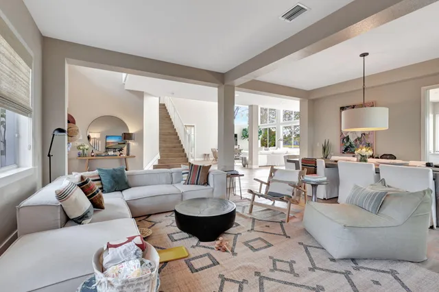 a living room with furniture fireplace and a large window