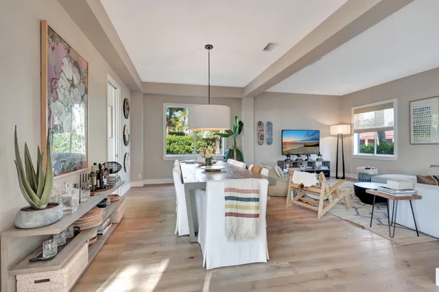 a living room with furniture a chandelier and a flat screen tv