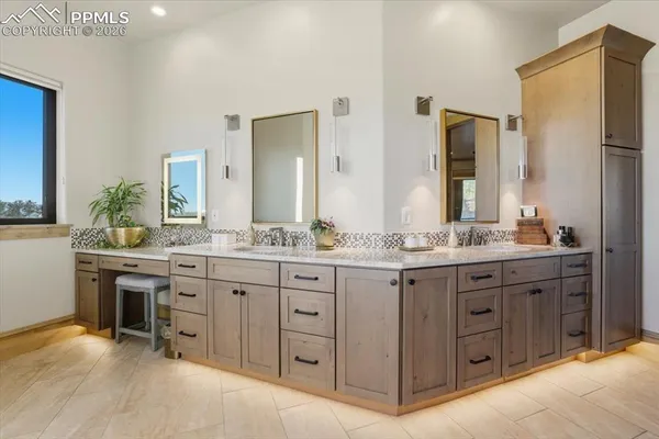 a bathroom with a granite countertop double vanity sink and a mirror