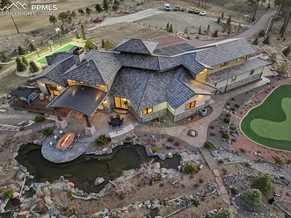 an aerial view of a house with a yard