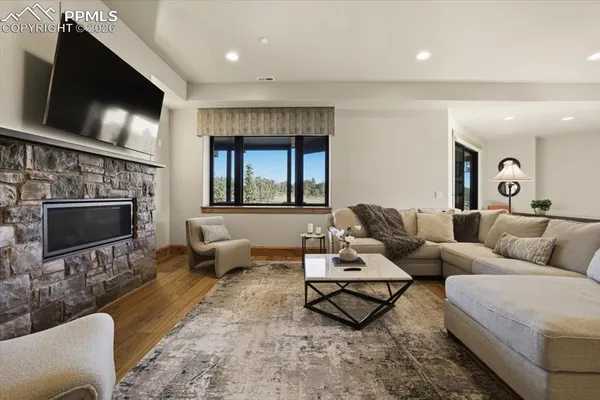 a living room with furniture a flat screen tv and a fireplace