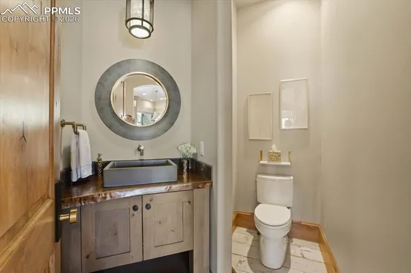 a bathroom with a toilet a sink and a mirror