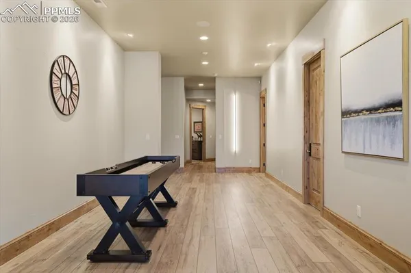 a view of a hallway with wooden floor