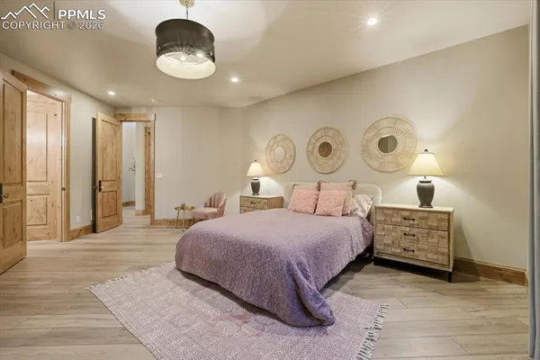 a bedroom with a bed and a chandelier