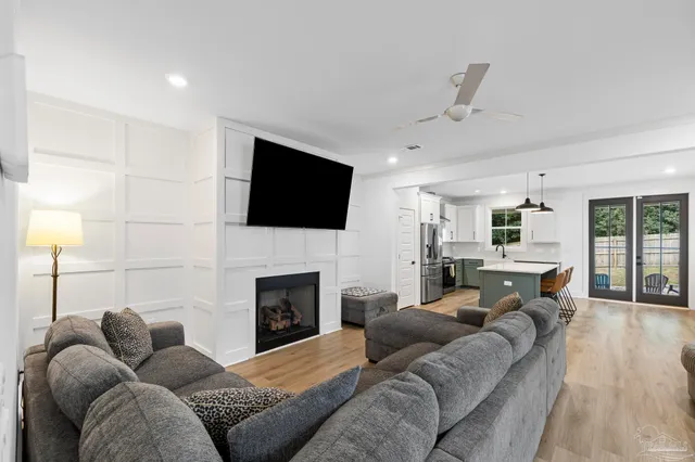 a kitchen with stainless steel appliances a sink stove and white cabinets