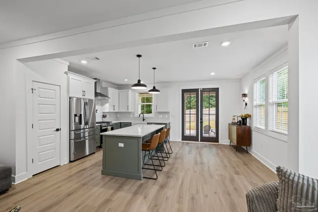 a kitchen with stainless steel appliances a refrigerator stove and microwave