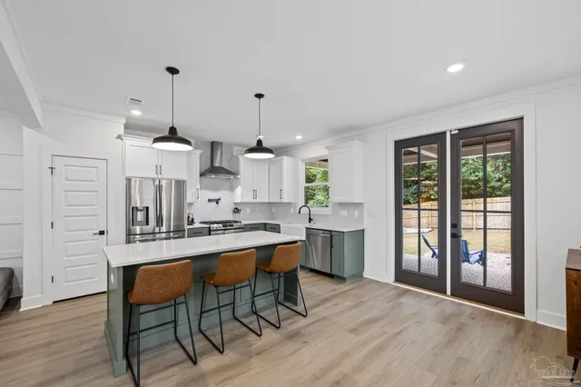 a kitchen with cabinets appliances a sink and a window