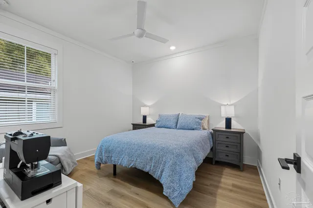 a bedroom with a bed and wooden floor