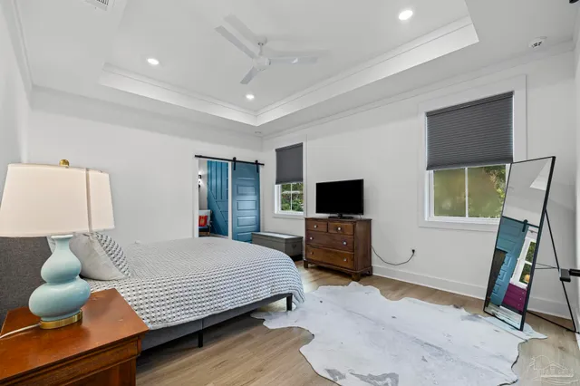 a backyard of a house with table and chairs and wooden fence