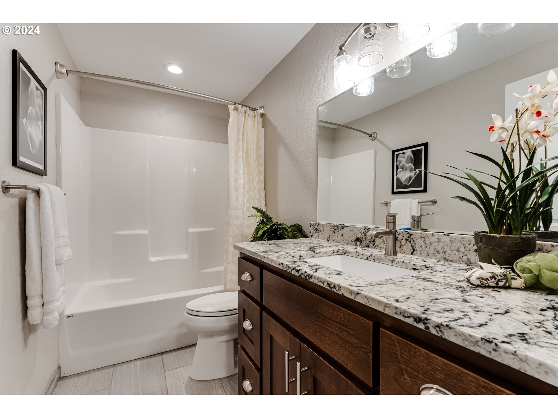 4288 Cole Way Springfield, OR 97478 - Photo 15 of 21 a bathroom with a granite countertop sink a toilet a mirror a vanity and shower