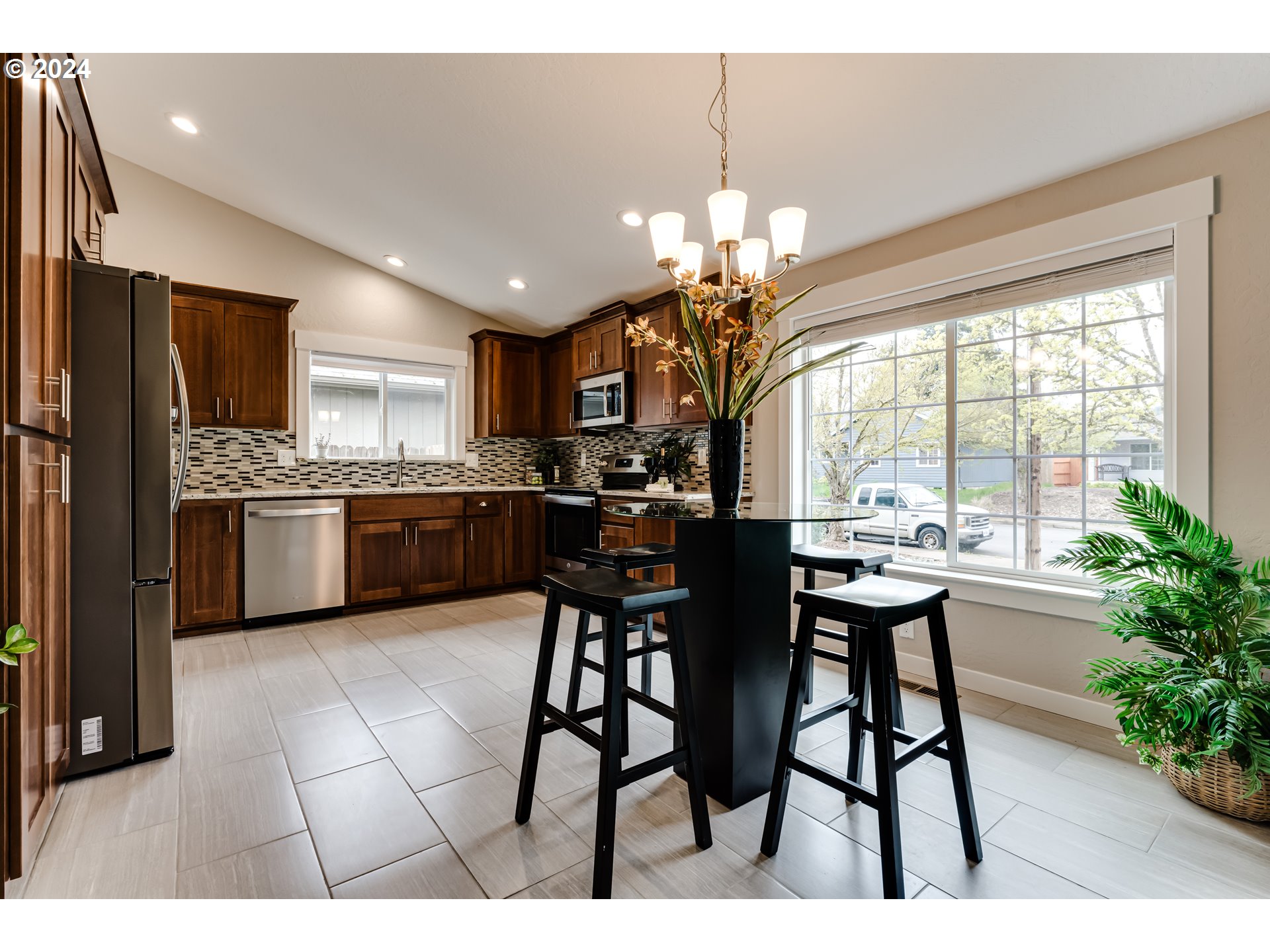 4288 Cole Way Springfield, OR 97478 - Photo 4 of 21 a open dining room with stainless steel appliances kitchen island granite countertop furniture a chandelier a kitchen view and a chandelier