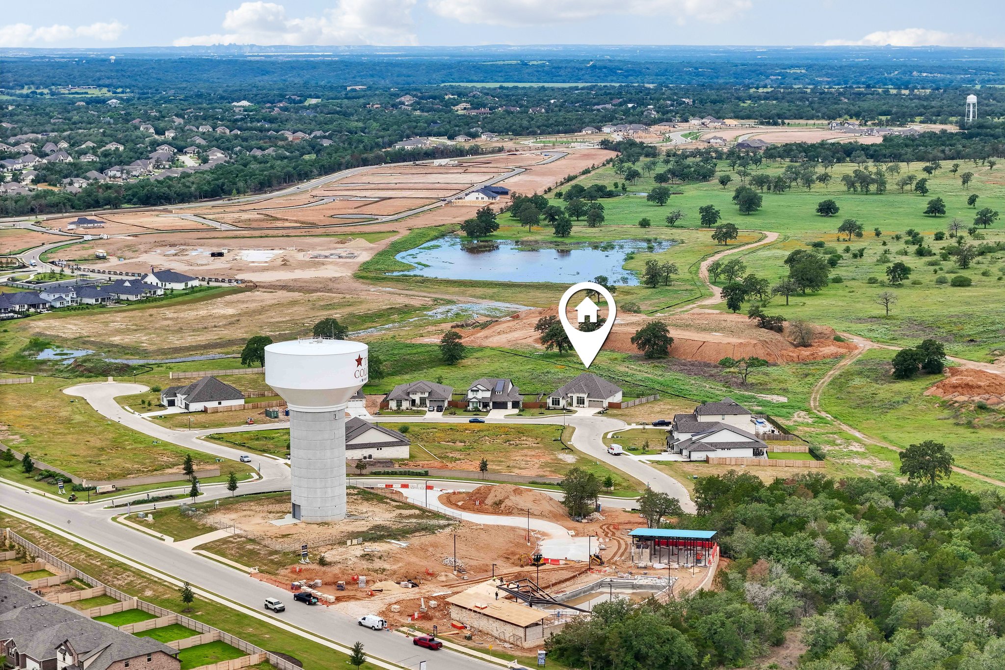 130 Firethorn Loop Bastrop, TX 78602 - Photo 33 of 38 Aerial perspective showcasing a residential development with established homes and ongoing new construction