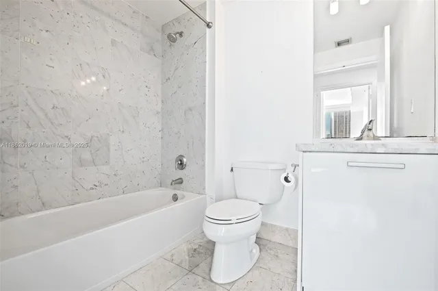 a bathroom with a toilet and a bathtub