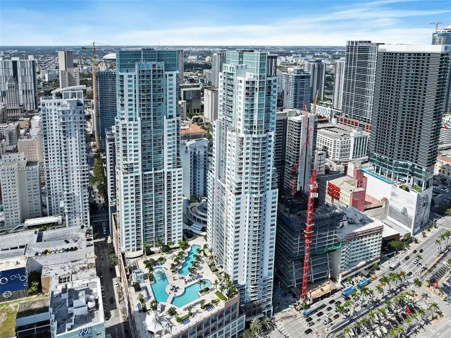 a view of front door with wooden floor and windows