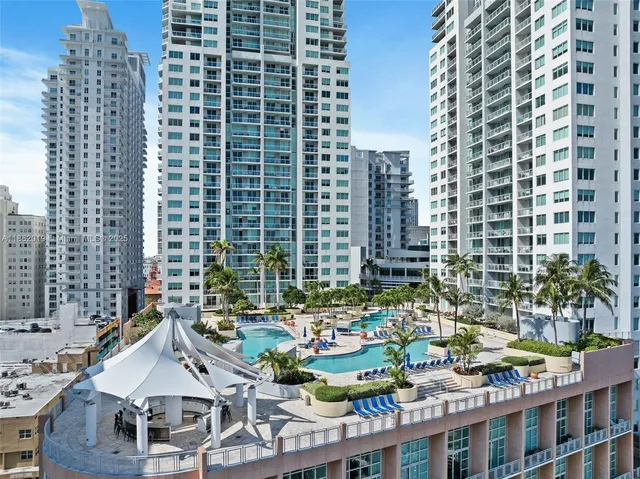 a view of a swimming pool with outdoor seating and plants