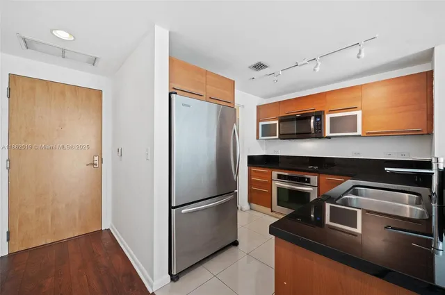 a kitchen with stainless steel appliances a refrigerator and a stove