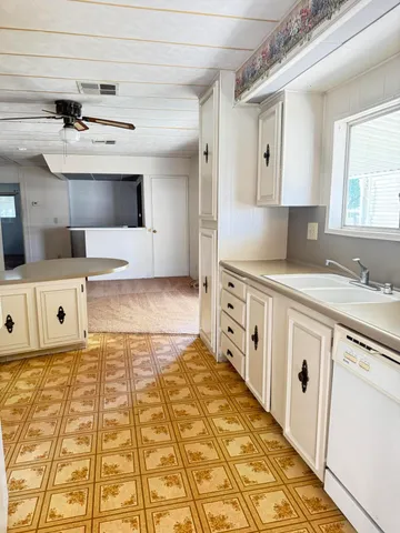 a kitchen with stainless steel appliances a stove a sink and a refrigerator