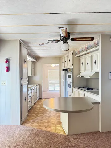 a kitchen with stainless steel appliances granite countertop a sink and a refrigerator