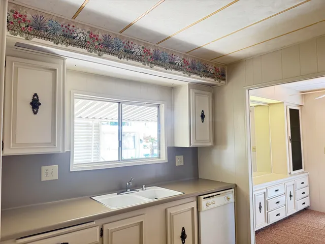 a view of cabinets a sink and a window