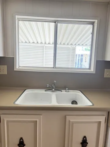a bathroom with a sink and a window
