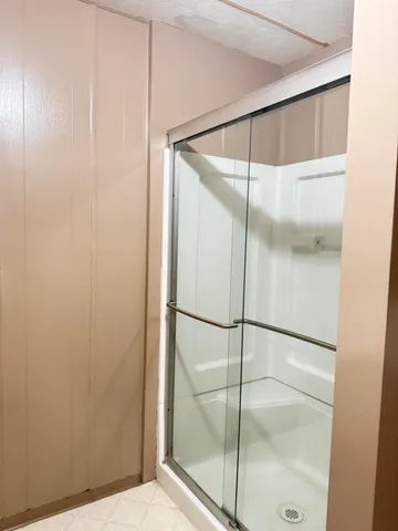 a bathroom with a glass shower door