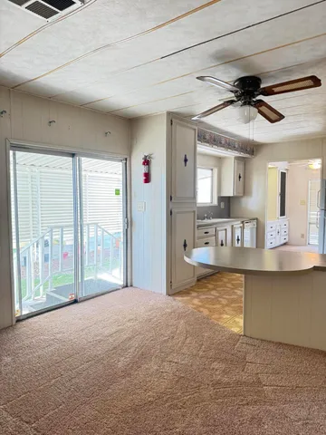 a view of a kitchen with a sink and a window