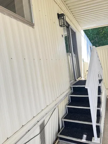 a view of entryway with wooden floor and stairs