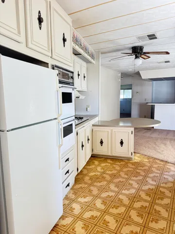 a kitchen with stainless steel appliances a refrigerator sink and cabinets