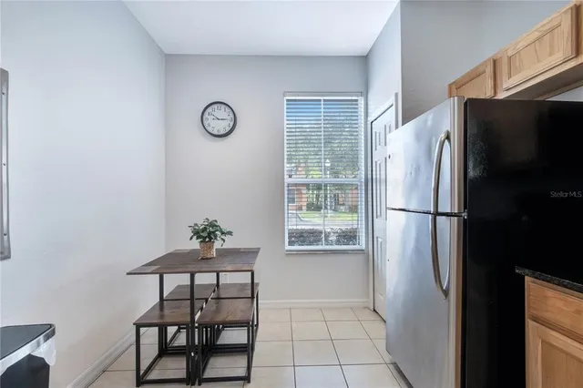 a kitchen with stainless steel appliances granite countertop a refrigerator sink and stove
