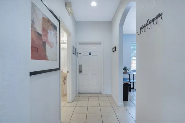 a view of a hallway with living room and stairs