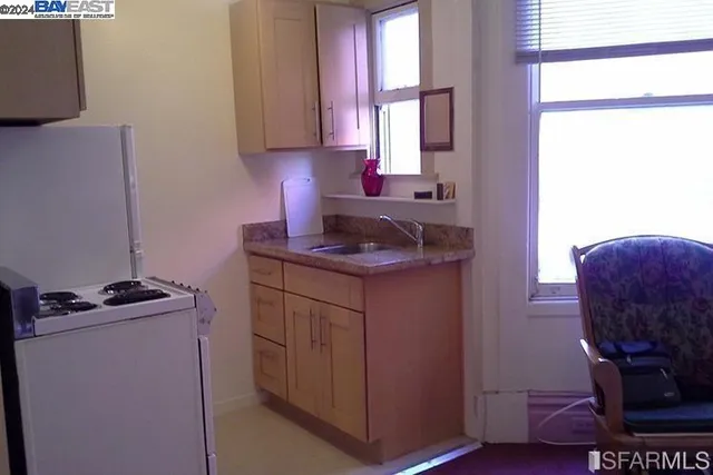 a kitchen with a sink cabinets and a window
