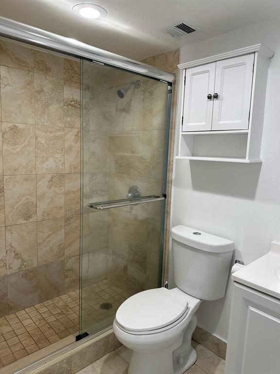 9331 Southwest 4th Street, Unit 104B Miami, FL 33174 - Photo 3 of 11 a white toilet sitting next to a bathroom sink