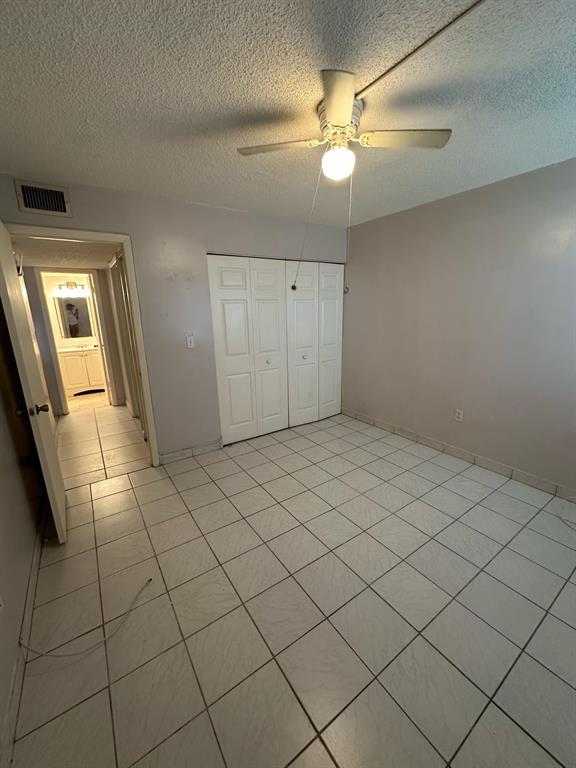 9331 Southwest 4th Street, Unit 104B Miami, FL 33174 - Photo 6 of 11 a view of an empty room and chandelier fan