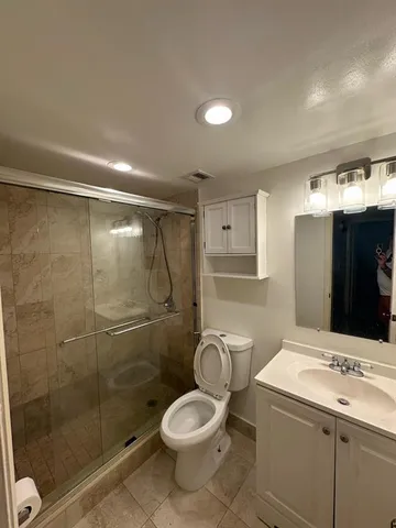 a bathroom with a sink toilet and shower
