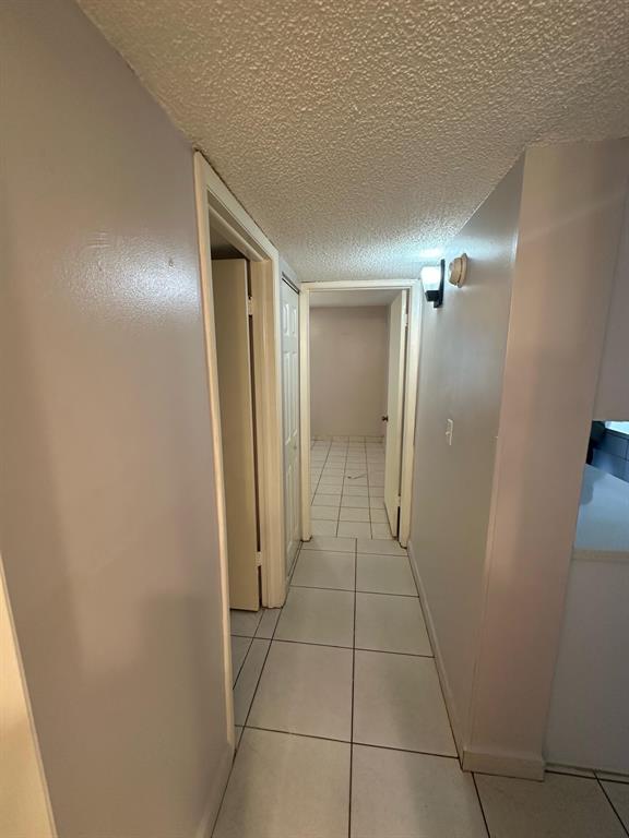 9331 Southwest 4th Street, Unit 104B Miami, FL 33174 - Photo 10 of 11 a view of hallway with an empty space and a mirror
