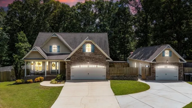 a front view of a house with a yard and garage