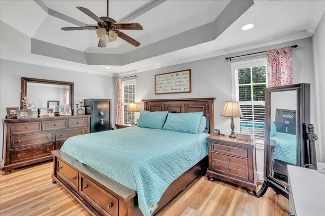a bedroom with a large bed and a chandelier