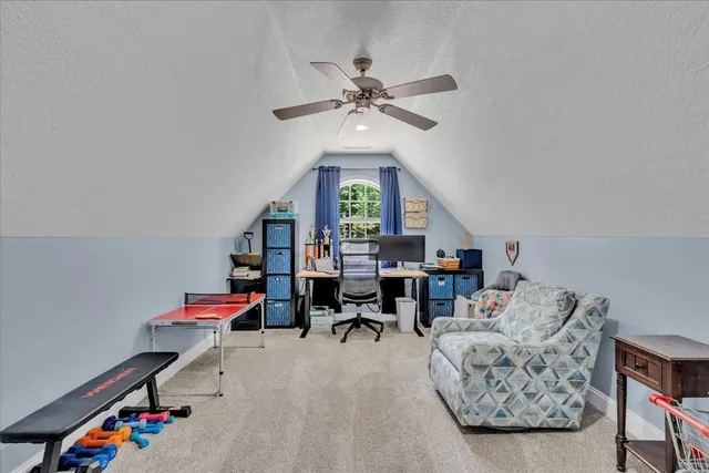 a living room with furniture gym equipment and a chandelier