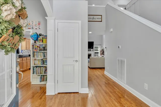 a view of a hallway with wooden floor and closet