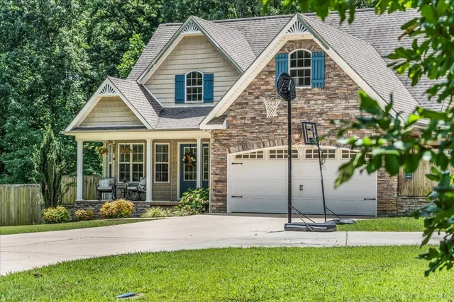 a front view of a house with a yard and garage